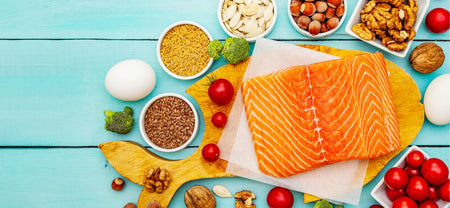 The image shows a platter of meat with fruits and nuts, to show the health benefits of omega 3 fatty acids