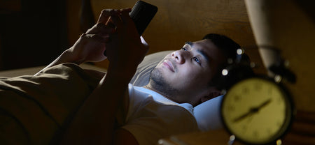 Man disturbs his sleep health by increasing mobile screen time. Improve sleep quality with recovery from digital overload.