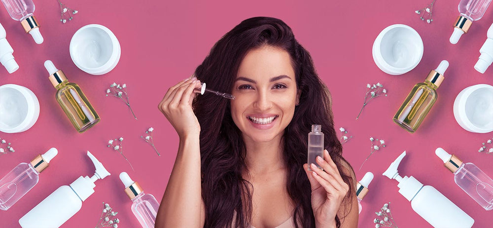 A smiling woman with flawless skin applying face serum for radiant skin